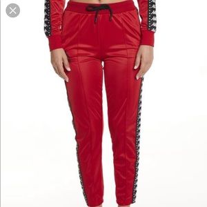 Red Kappa track pants.